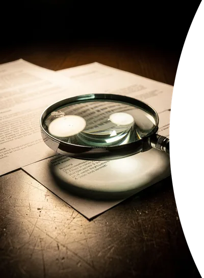Magnifying glass examining documents